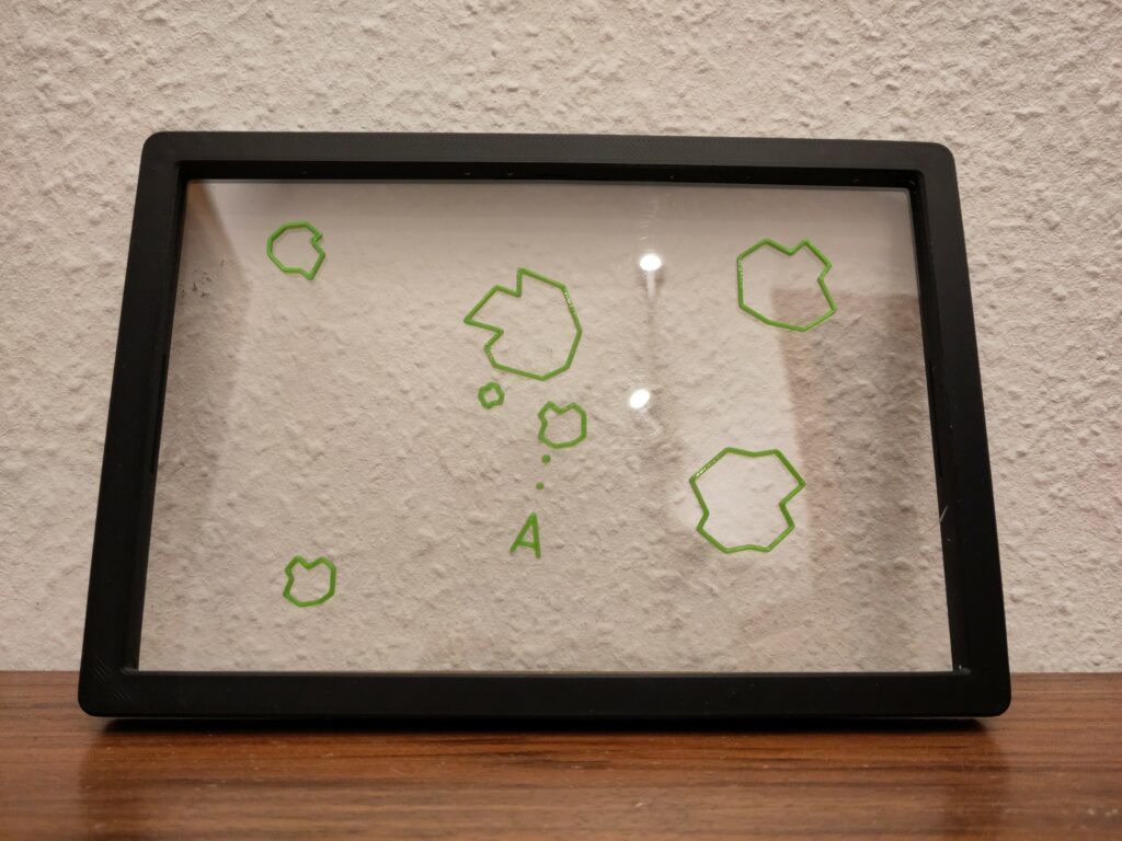 3d printed siluette of an scene from the videogame Asteroids, on an sheet